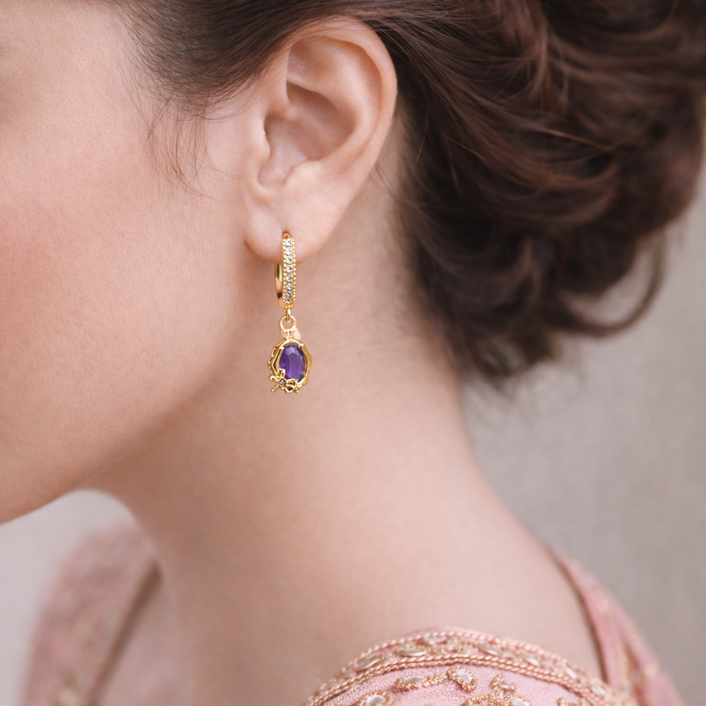 Gold huggie earrings with purple teardrop crystal